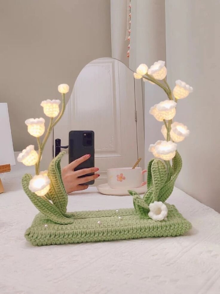 Support mirroir vert avec des fleurs blanches